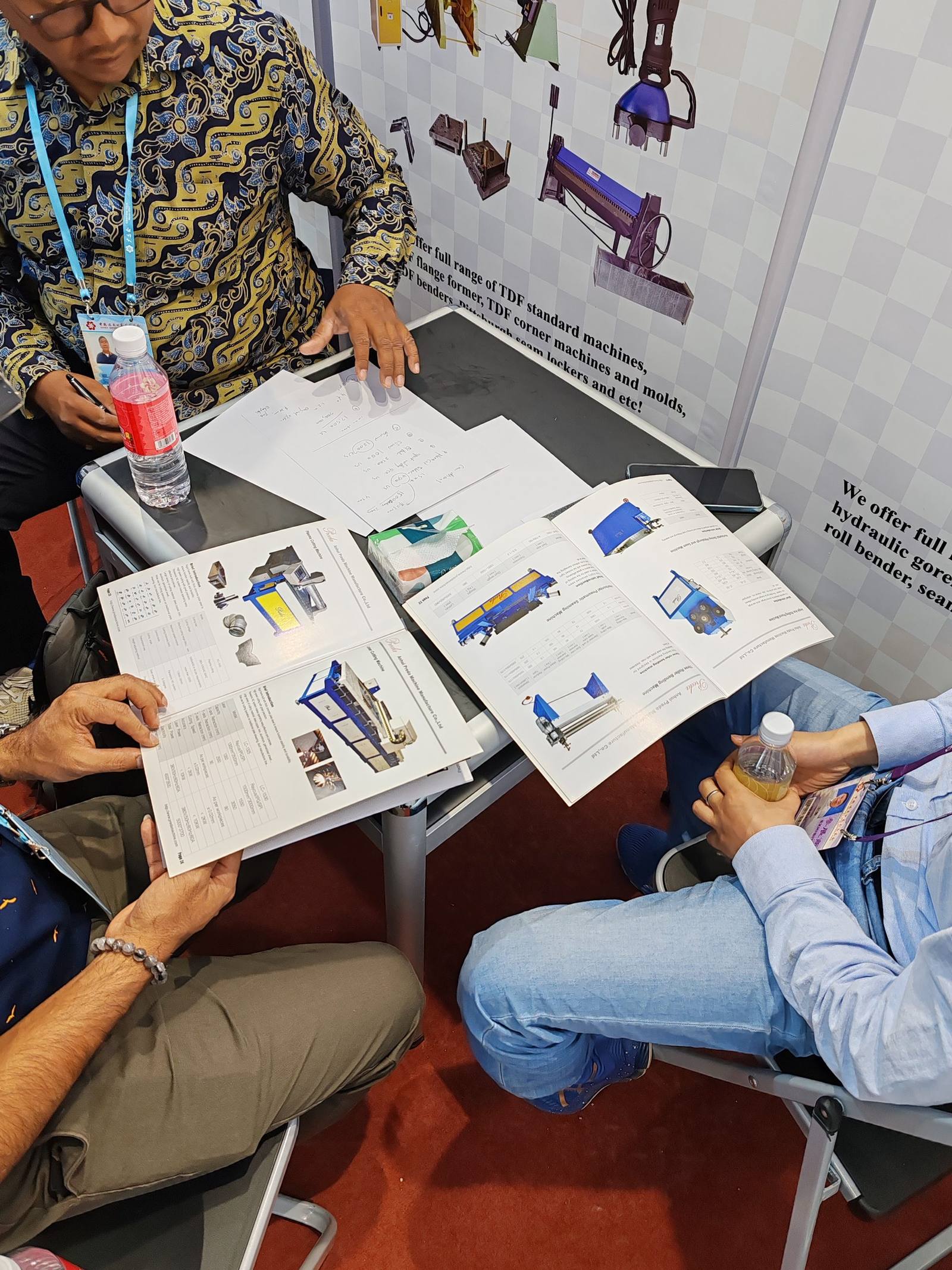 International clients reviewing product catalogs at our booth