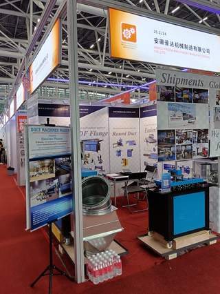 Canton Fair booth overview with spiral duct samples and equipment