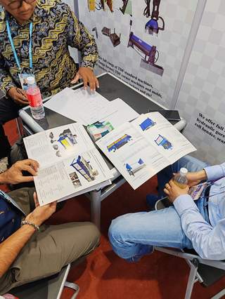 International clients reviewing product catalogs at our booth
