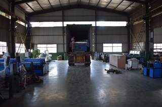 Container truck backed into factory loading bay