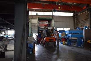 Forklift loading machine into container